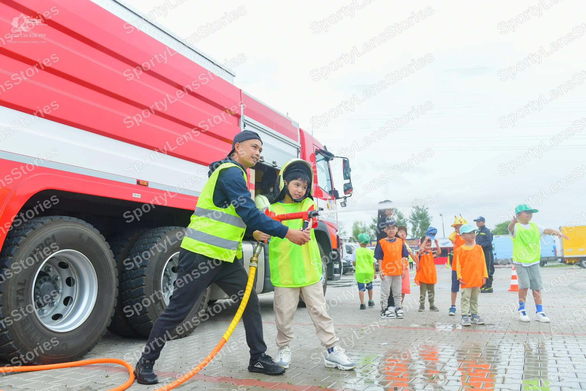 Dancesport competitor: Male:** (The man operating the hose) - Neon Yellow High-Visibility Vest - Fabric