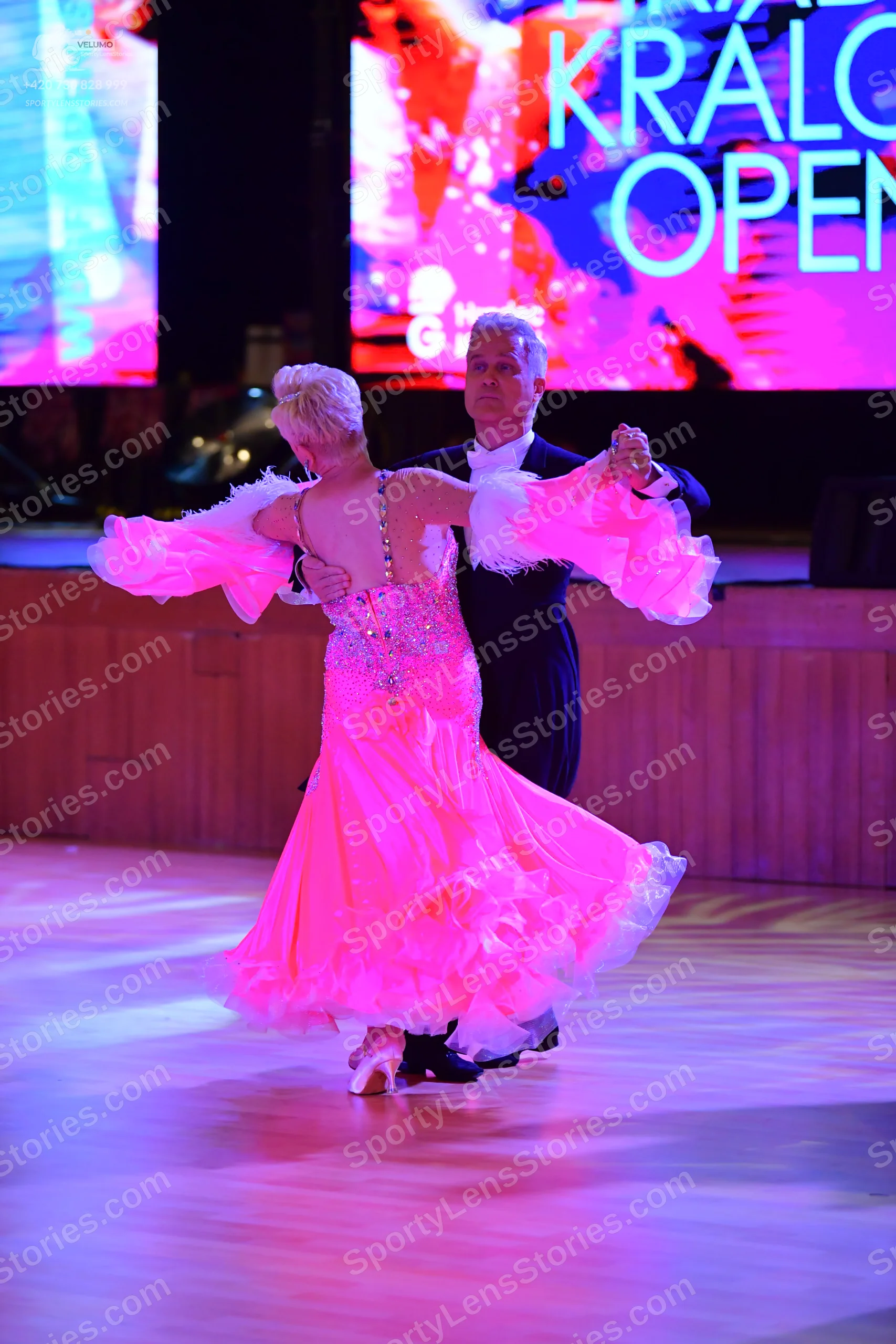 Dancesport competitor: ** Black tail suit
*   **Fabric:** Appears to be a shiny fabric, likely satin or