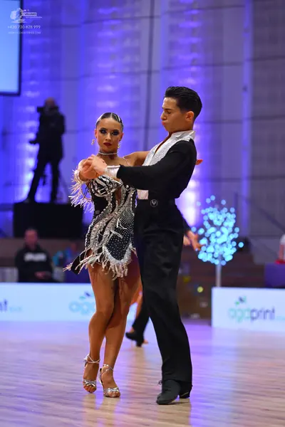 Dancesport competitor: Male dancer: black dance shirt with white satin panels and black trousers