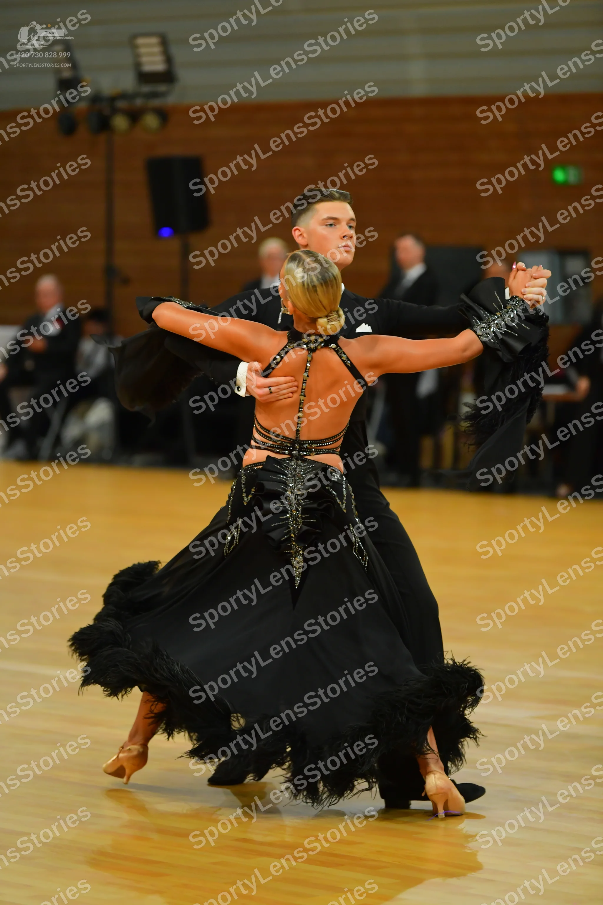 Dancesport competitor: Male**
*   **Color:** Black
*   **Fabric:** Likely satin or a similar smooth fab