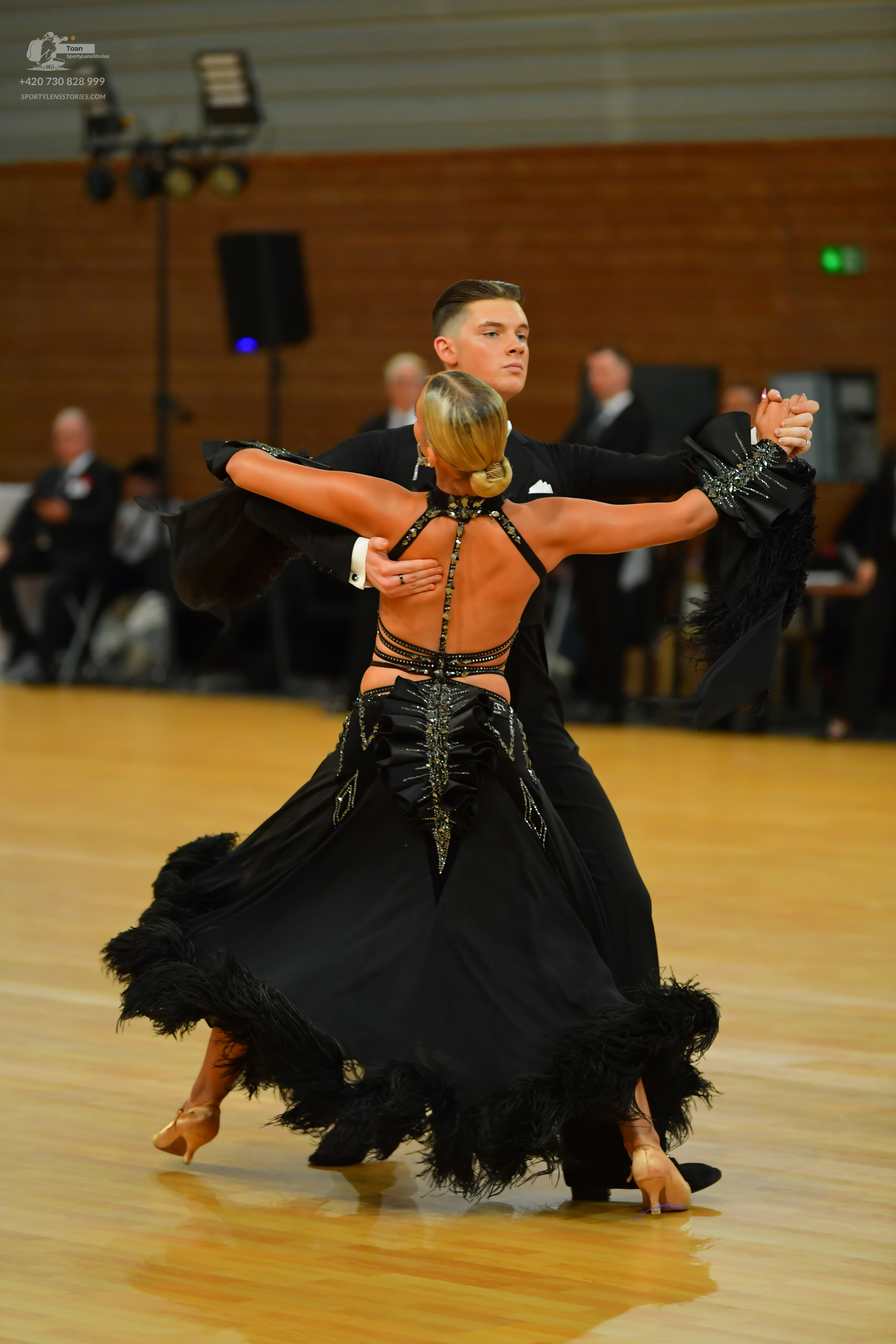 Dancesport competitor: Male**
*   **Color:** Black
*   **Fabric:** Likely satin or a similar smooth fab