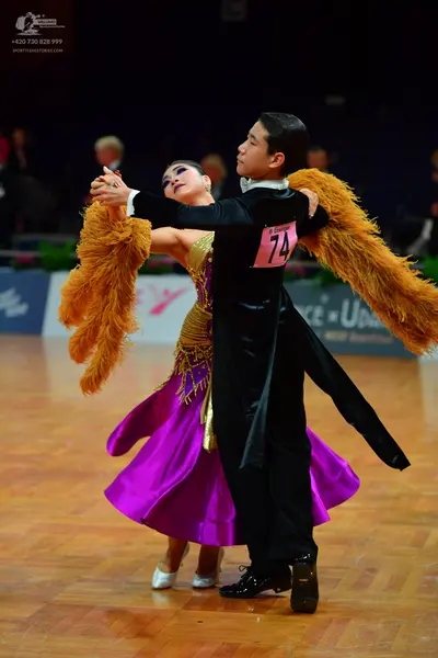 Dancesport competitor: Male dancer: black suit with a long tailcoat and white collar