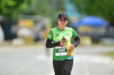 Marathon runner #5367: Runner 1: green jersey over a black long-sleeved shirt, black pants, black cap, 