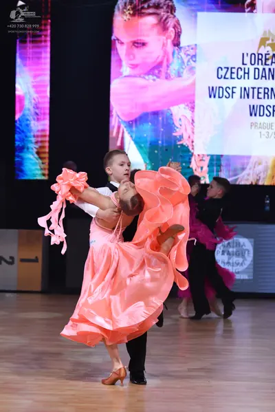 Dancesport competitor: Male dancer: white long-sleeved shirt with black trousers