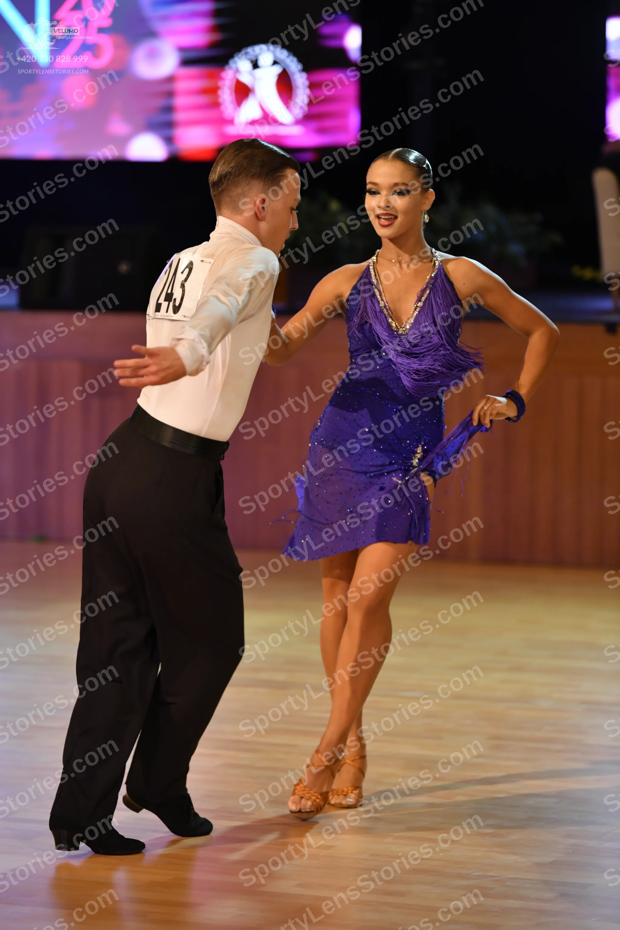 Dancesport competitor: Male:** Black tailsuit with sequin lapels