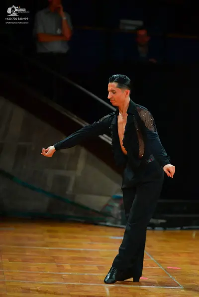 Dancesport competitor: Male dancer: black long-sleeved shirt with sheer side panels and black trousers