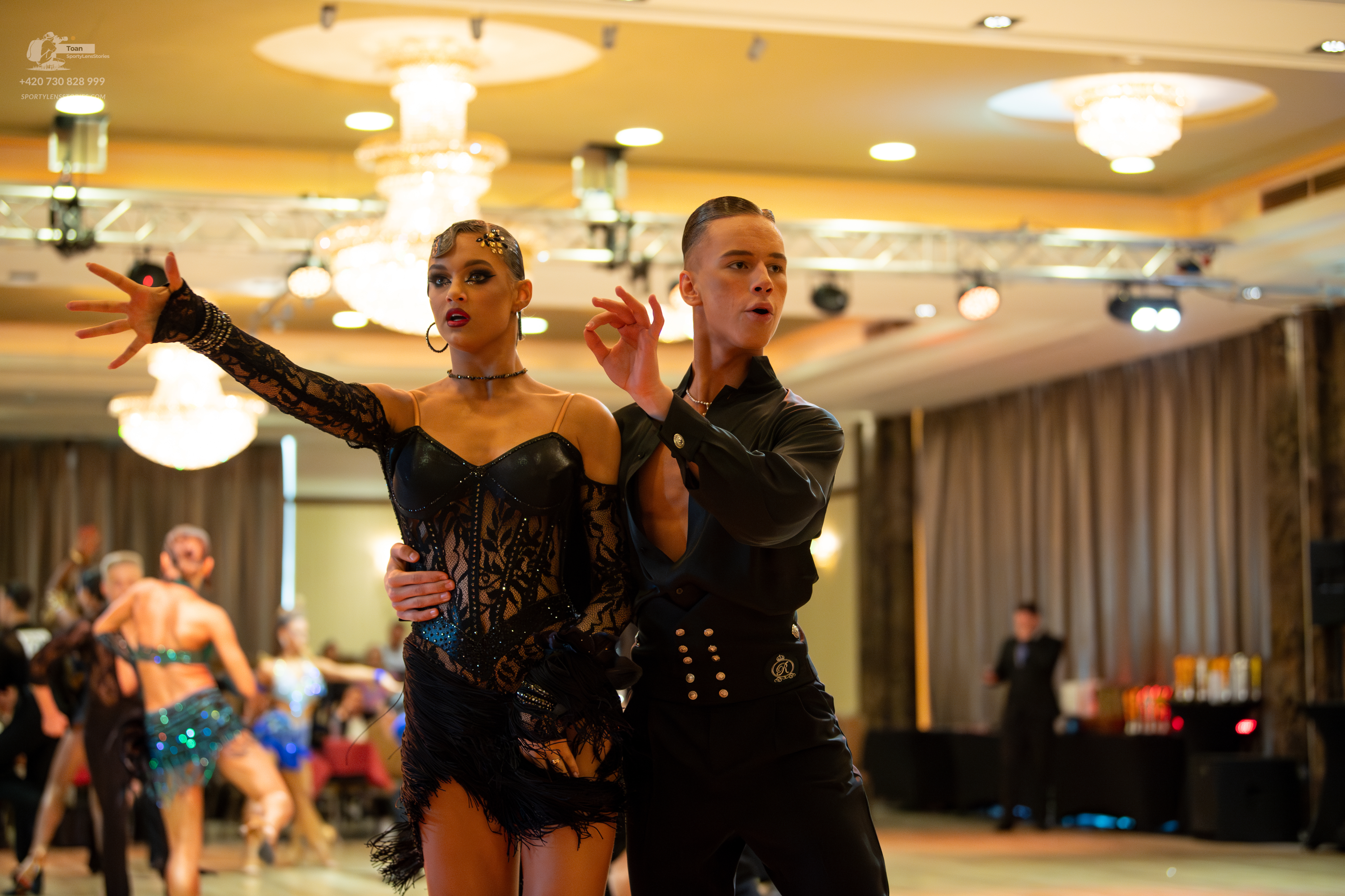 Dancesport competitor: Main female dancer: black latin dress with lace and mesh sleeves and bodice, bla