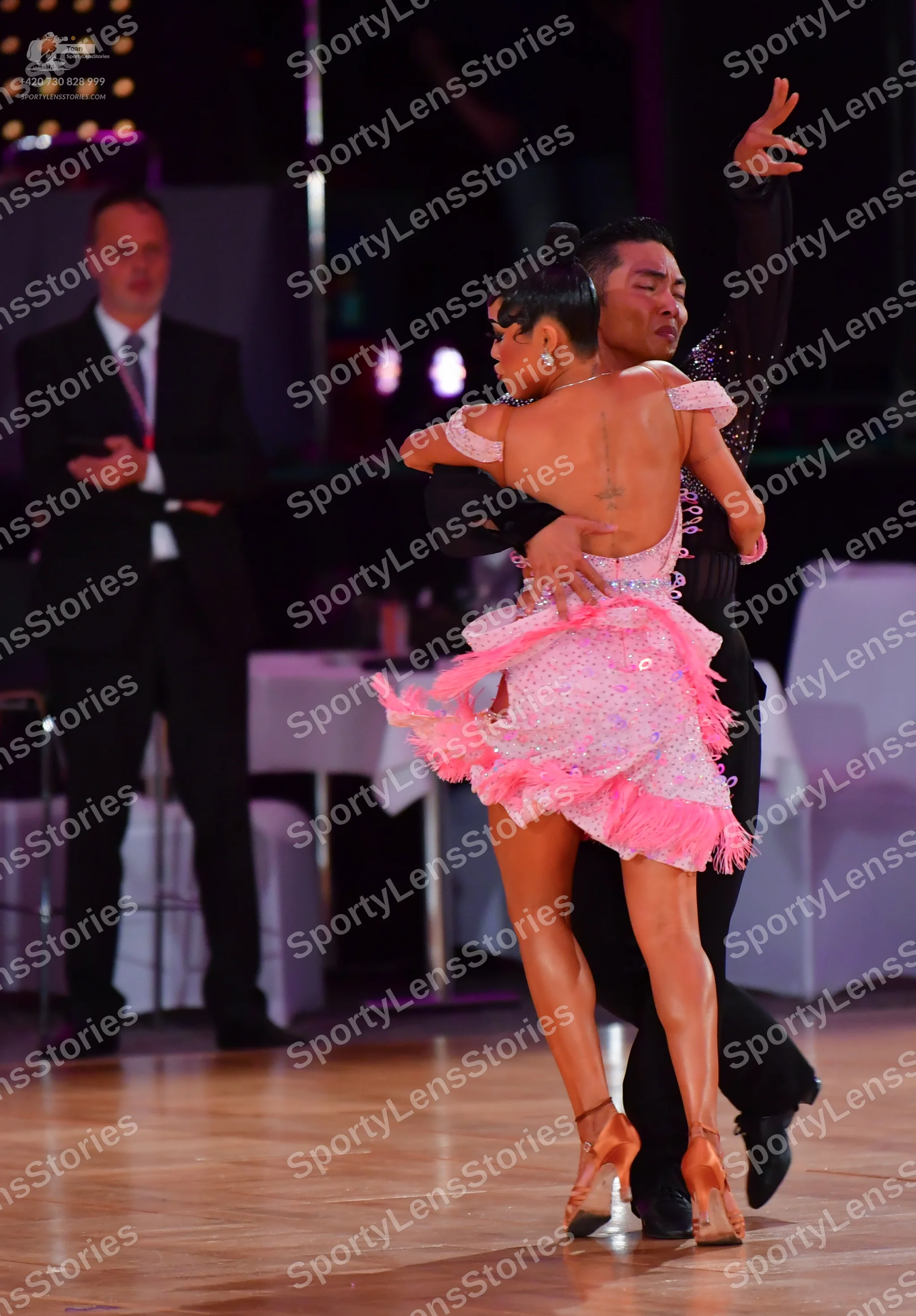 Dancesport competitor #73: Female dancer: pink Latin dress with sequins/rhinestones and a ruffled, fringed 