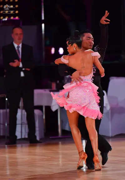 Dancesport competitor #73: Female dancer: pink Latin dress with sequins/rhinestones and a ruffled, fringed 