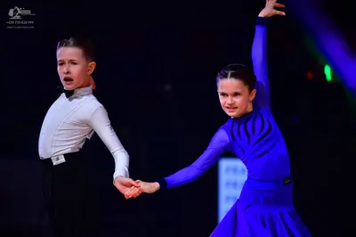 Dancesport competitor: Male dancer: white long-sleeved shirt and black trousers