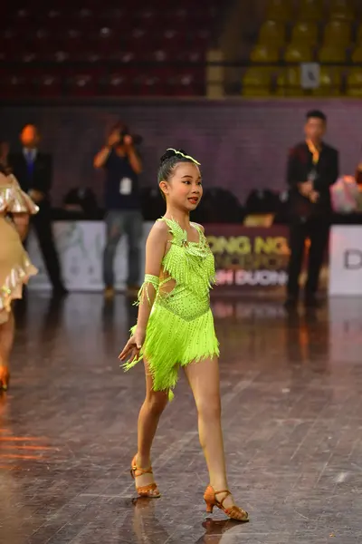 Dancesport competitor: Female dancer: lime green Latin dress with fringe