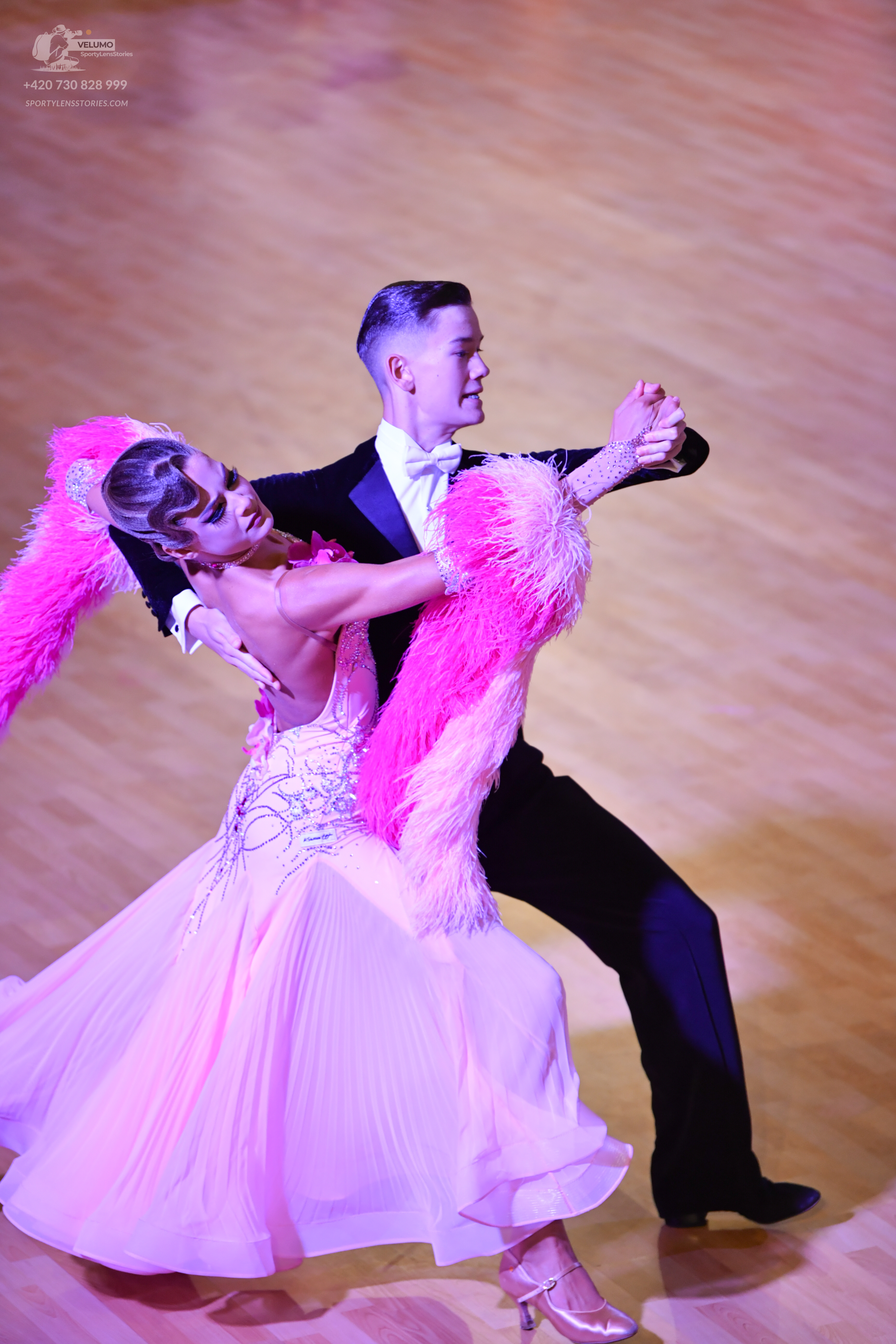 Dancesport competitor: Male:** Black tail suit with white satin lapels and a subtle sheen (likely sequi