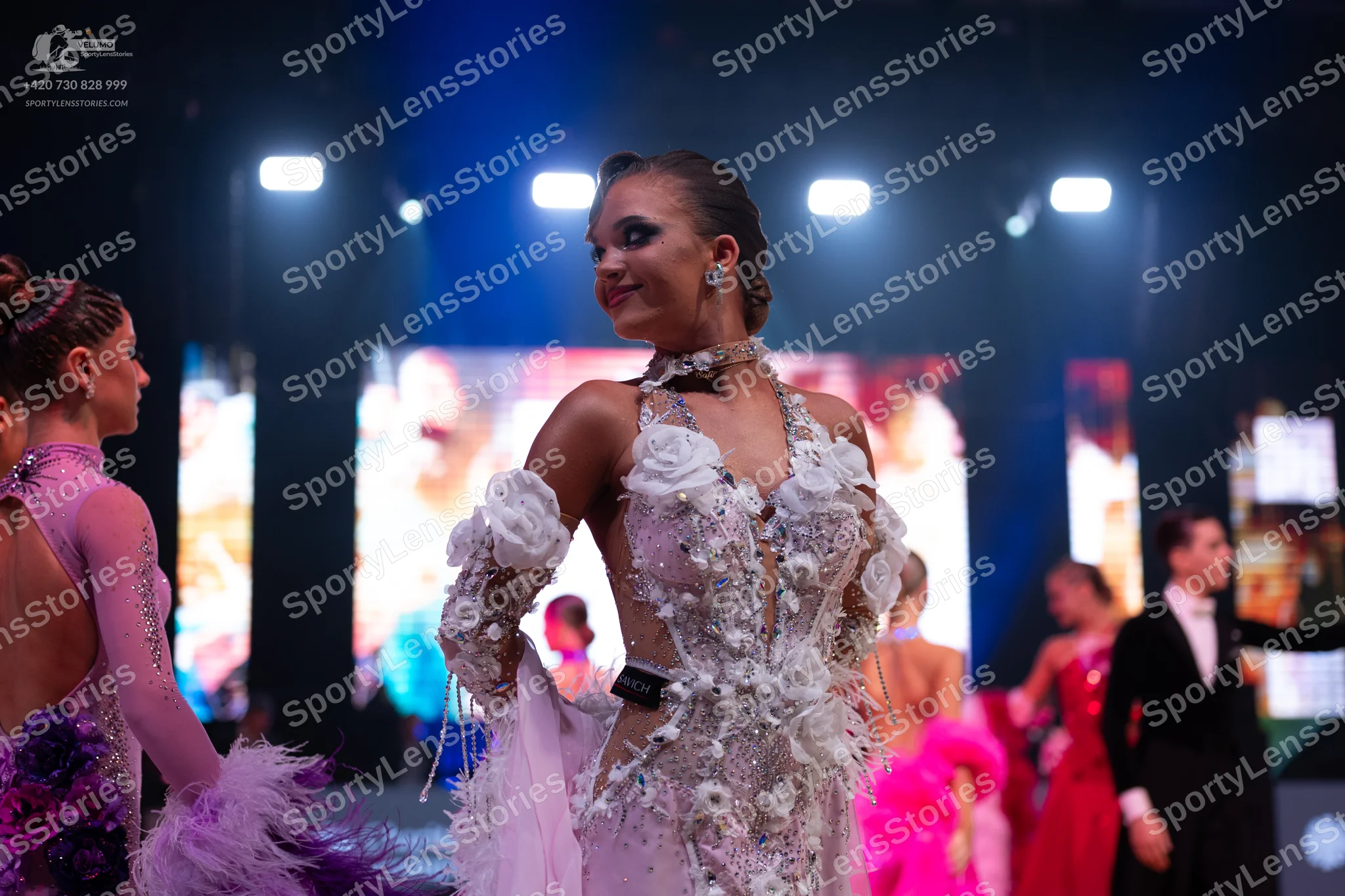 Dancesport competitor: Central female dancer: white/cream Latin dance dress with 3D floral lace appliqu