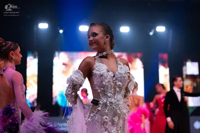 Dancesport competitor: Central female dancer: white/cream Latin dance dress with 3D floral lace appliqu