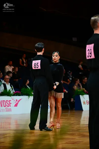 Dancesport competitor #85, #39: Male dancer (85): black long-sleeved shirt and black trousers