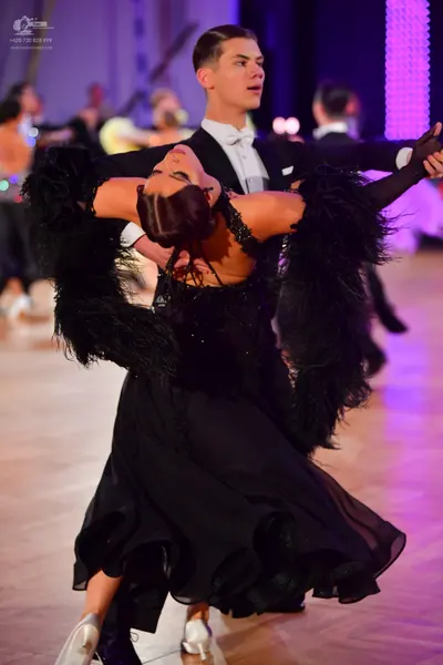 Dancesport competitor: Male dancer: black suit with a white shirt and white bow tie