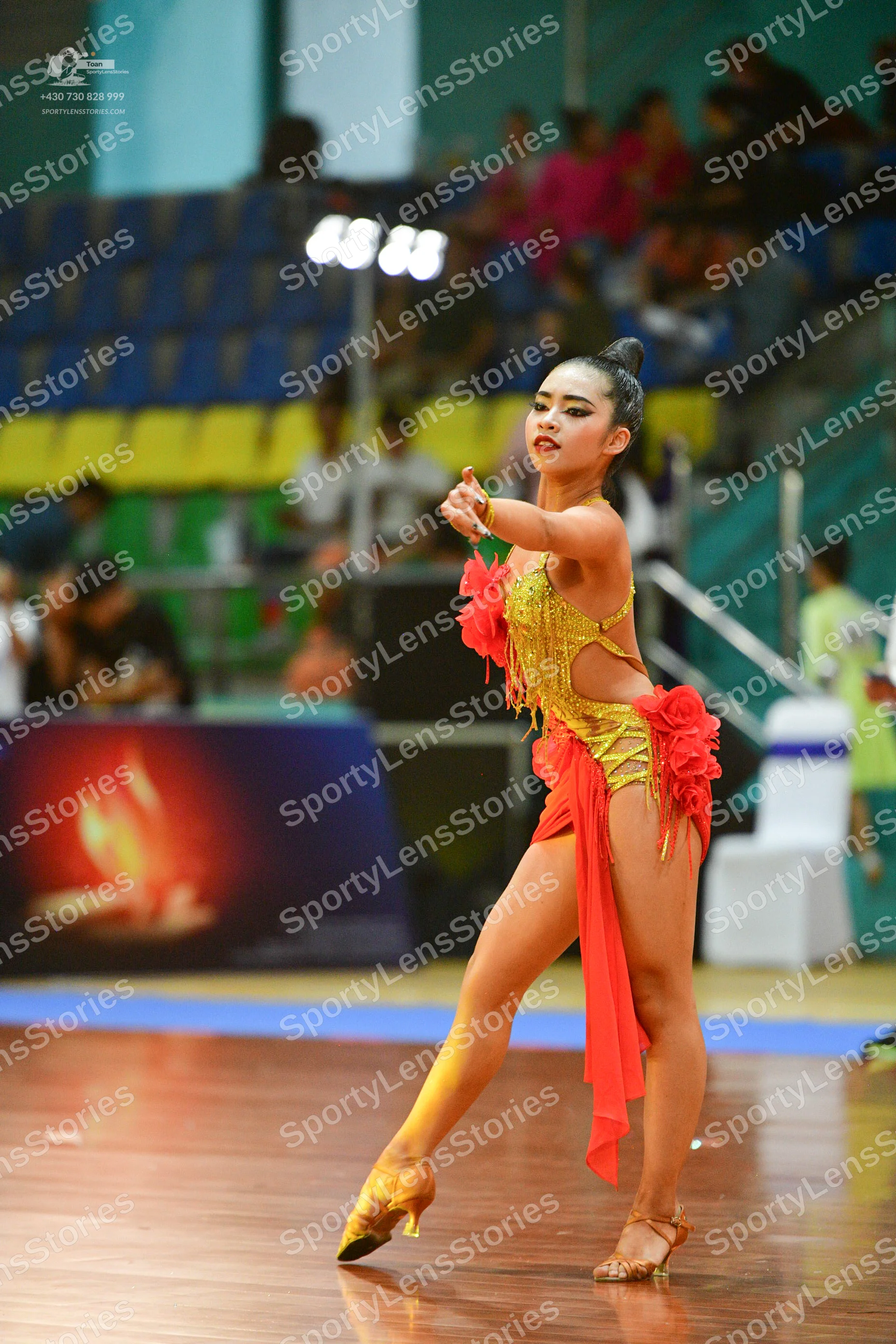 Dancesport competitor: ** Red Latin Dress
*   **Color:** Primarily Red
*   **Fabric:** Appears to be a 