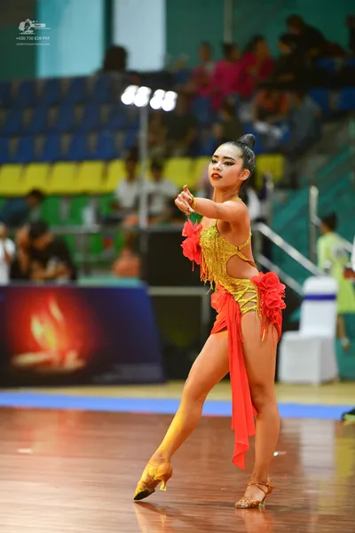 Dancesport competitor: ** Red Latin Dress
*   **Color:** Primarily Red
*   **Fabric:** Appears to be a 