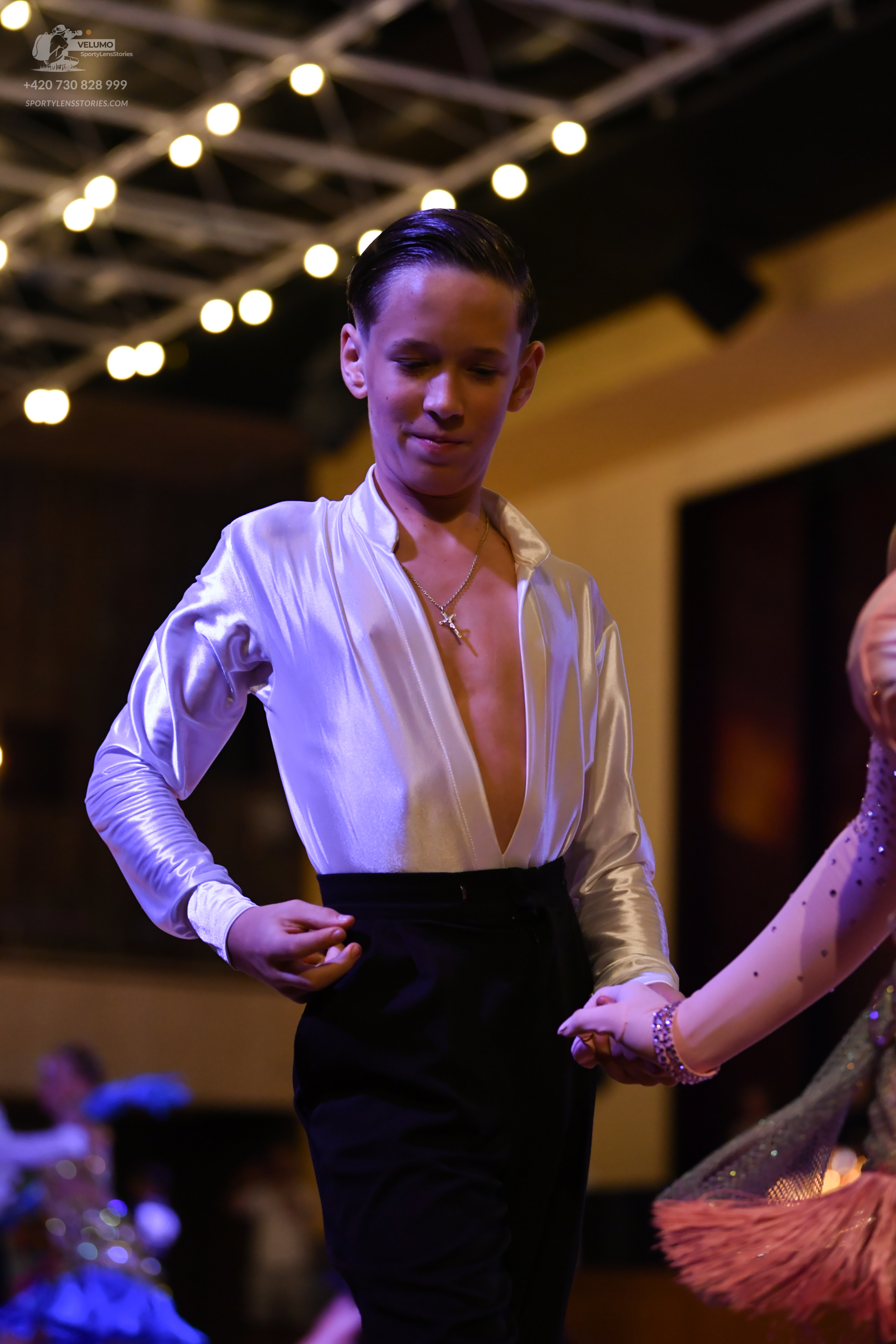 Dancesport competitor: Male:** Black tailsuit with sequin lapels
