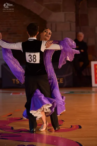Dancesport competitor #38: Male dancer: black vest over a white long-sleeved shirt, and black trousers
