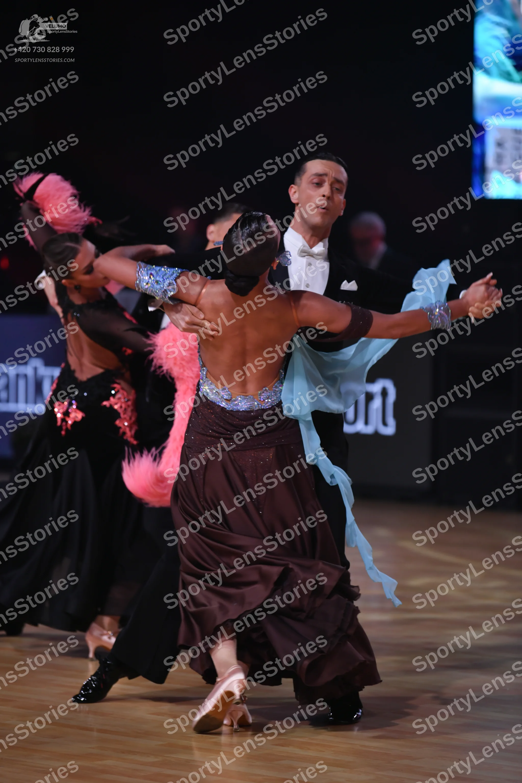 Dancesport competitor: Female dancer 1: black latin dress with pink sequin floral patterns