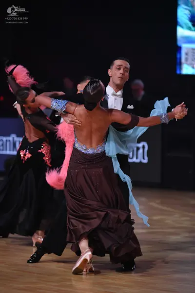 Dancesport competitor: Female dancer 1: black latin dress with pink sequin floral patterns