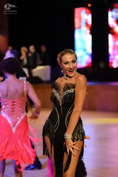 Dancesport competitor: ** Red Latin Dress
*   **Color:** Vibrant Red
*   **Fabric:** Shiny, possibly sa
