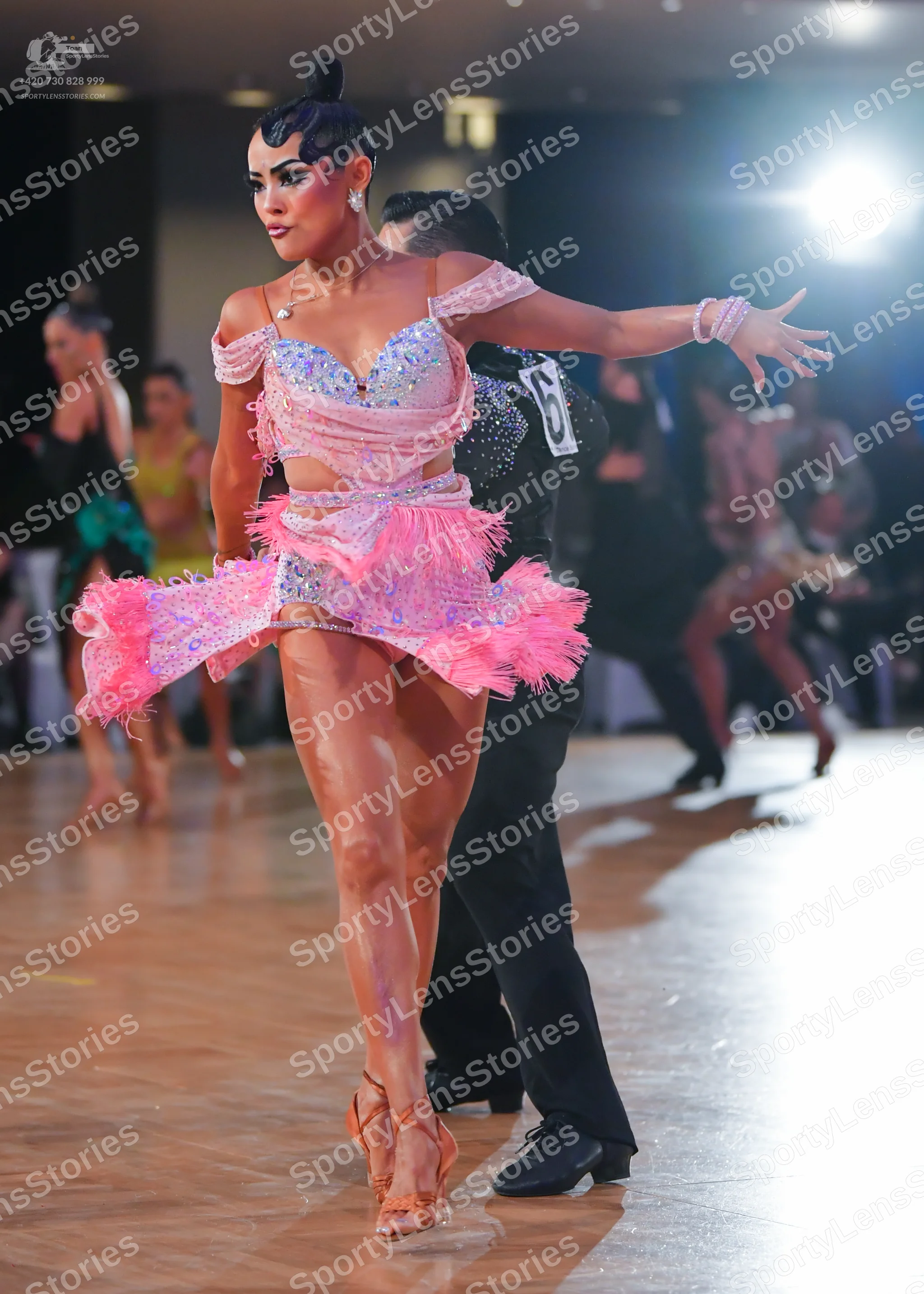 Dancesport competitor: Female dancer: light pink sequined latin dress with feathered/fringed skirt and 