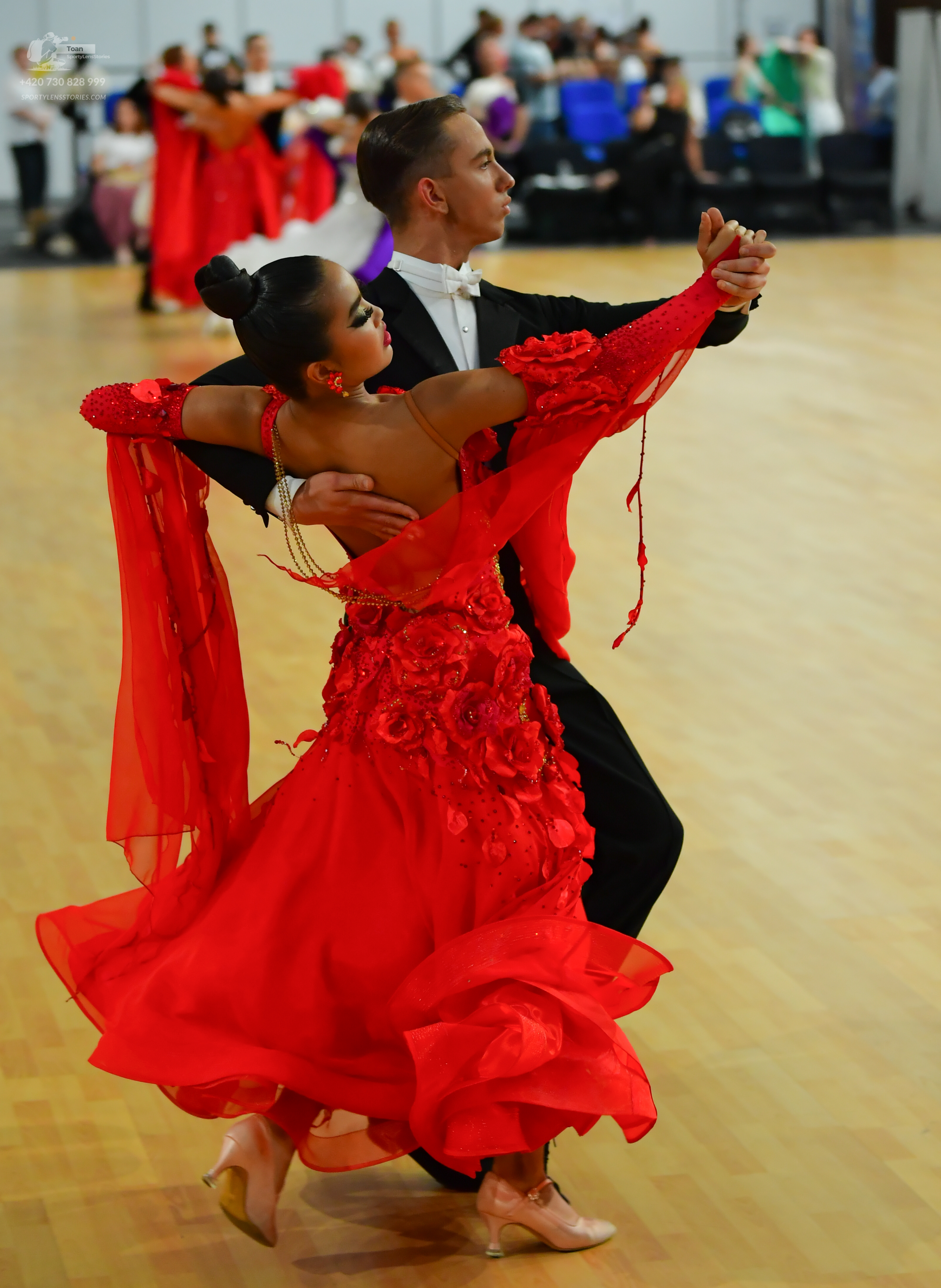 Dancesport competitor: ** Red Latin dress
*   **Color:** Primarily vibrant red
*   **Fabric:** Appears 