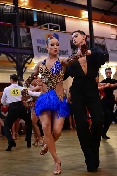Dancesport competitor #45: Female dancer: leopard print Latin dress with bright blue fringe skirt and blue/