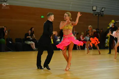 Dancesport competitor: Male dancer: black long-sleeved shirt and black trousers