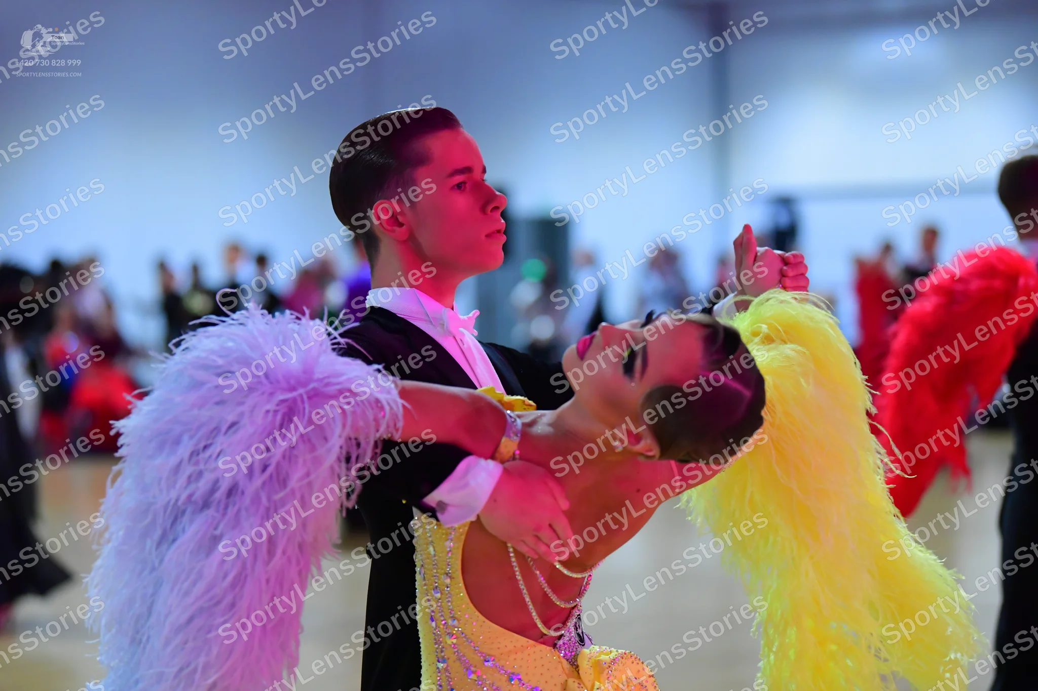 Dancesport competitor: Male dancer: black suit with a white shirt and white bow tie