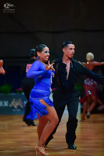 Dancesport competitor: Male dancer: black long-sleeved Latin shirt with subtle sparkling details and bl