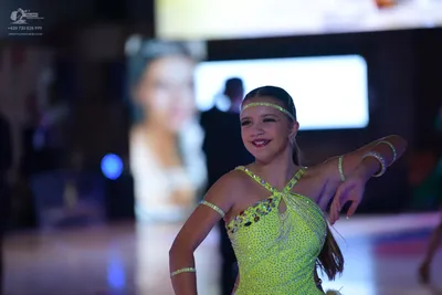 Dancesport competitor: Female dancer: bright yellow/lime green Latin dance costume with rhinestone and 