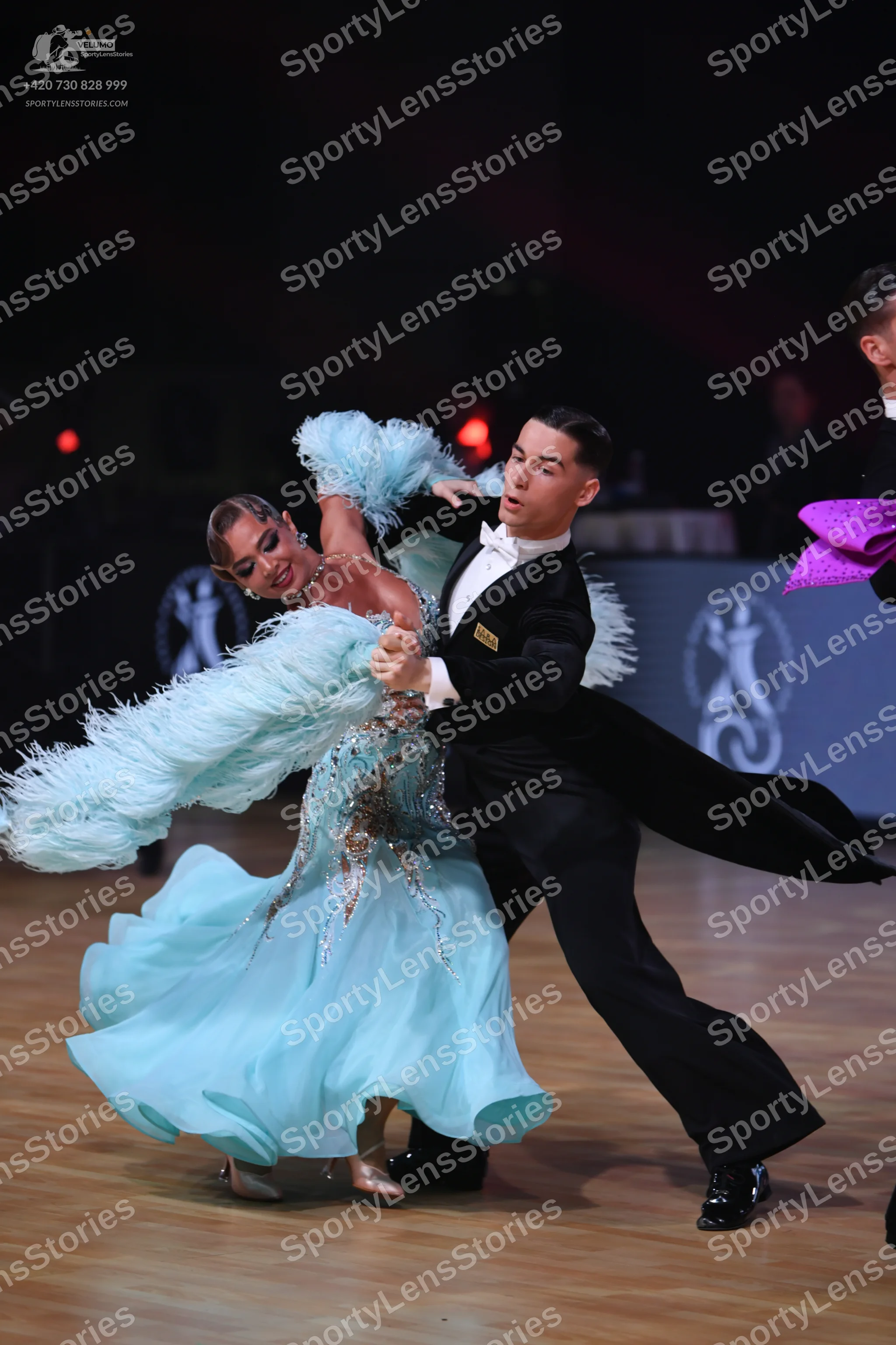 Dancesport competitor: Female dancer: light blue ballgown with an embellished bodice and large, volumin