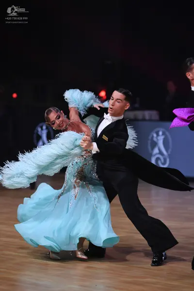 Dancesport competitor: Female dancer: light blue ballgown with an embellished bodice and large, volumin