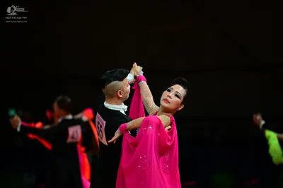 Dancesport competitor #55: Male dancer: black long-sleeved shirt with a white collar