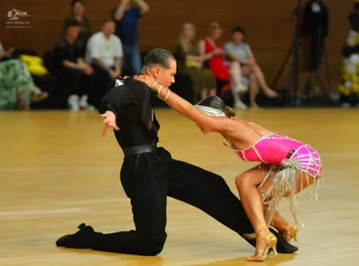 Dancesport competitor: Male dancer: black long-sleeved shirt and black trousers