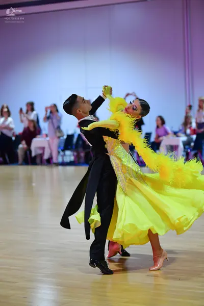 Dancesport competitor: Male dancer: black tailcoat with white shirt and black bowtie, and black dance s