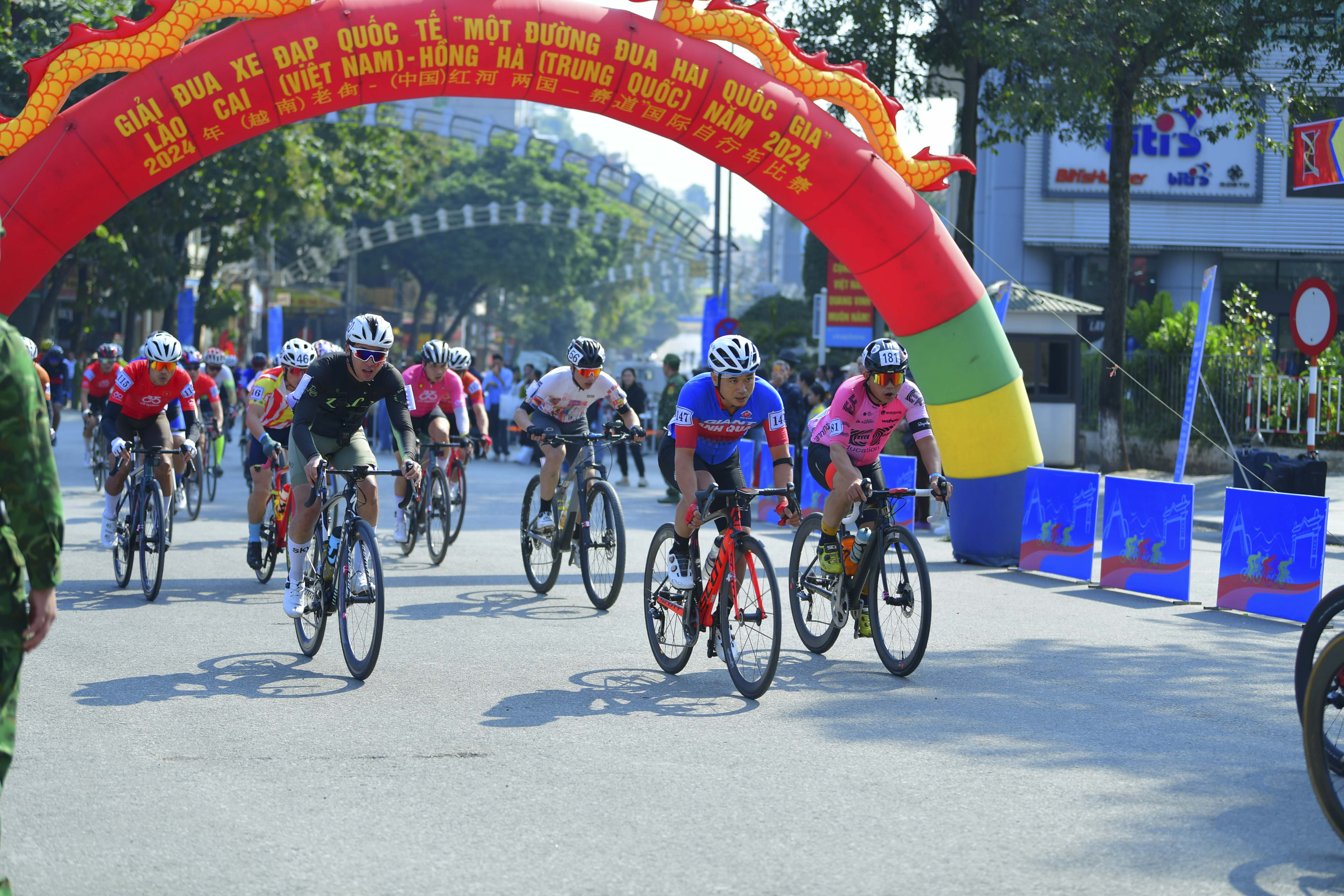 Cyclist: Cyclist 1: Red jersey with white accents, red shorts