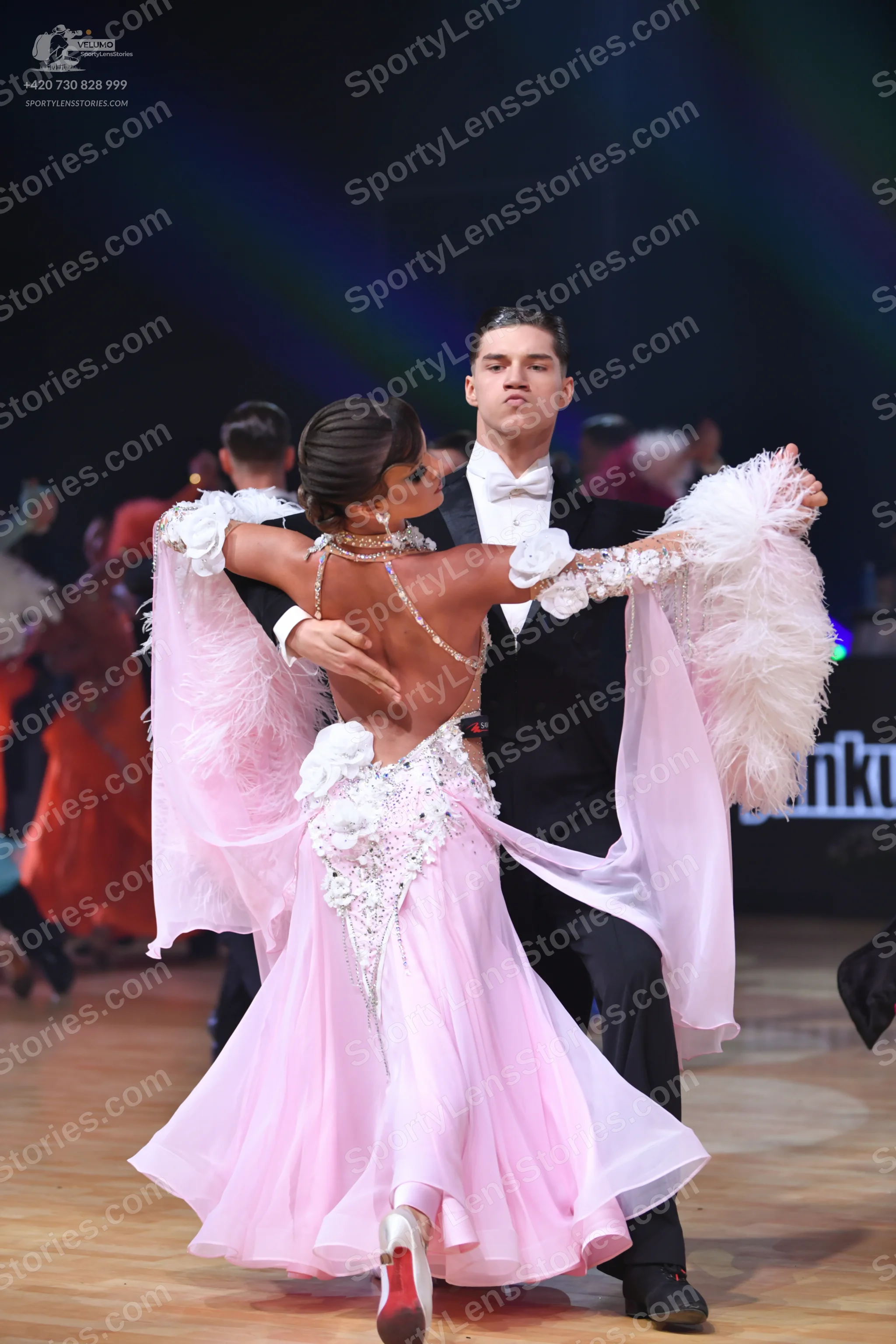 Dancesport competitor: Male dancer: black suit with a white shirt and white bow tie
