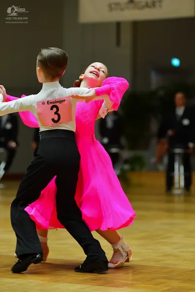 Dancesport competitor: Male dancer: white long-sleeved shirt and black trousers