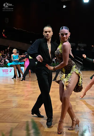 Dancesport competitor: Male dancer: black long-sleeved shirt and black trousers