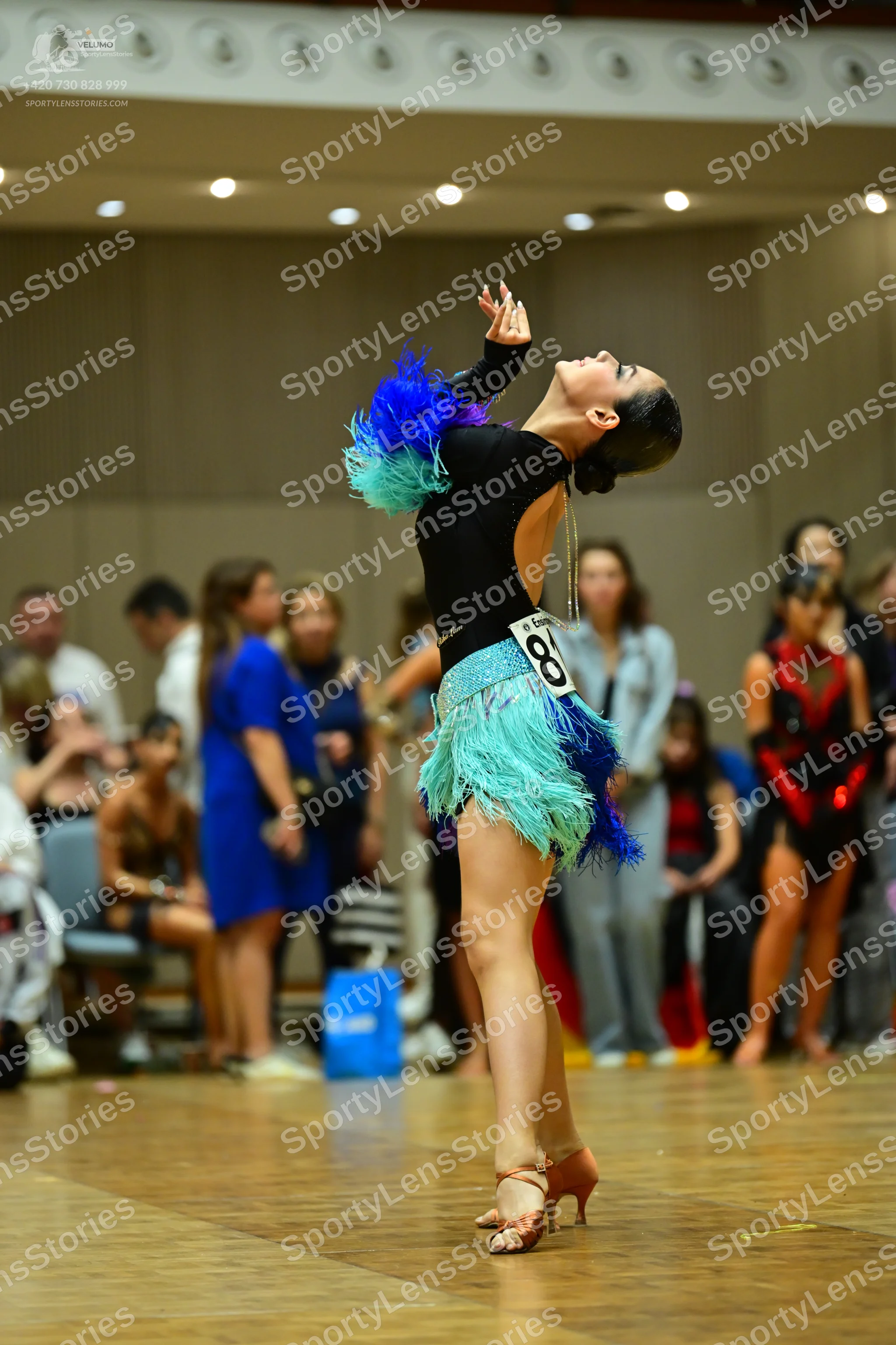 Dancesport competitor #81: Main dancer: black long-sleeved bodysuit with a skirt made of teal, light blue,