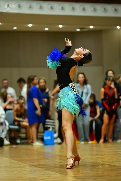Dancesport competitor #81: Main dancer: black long-sleeved bodysuit with a skirt made of teal, light blue, 