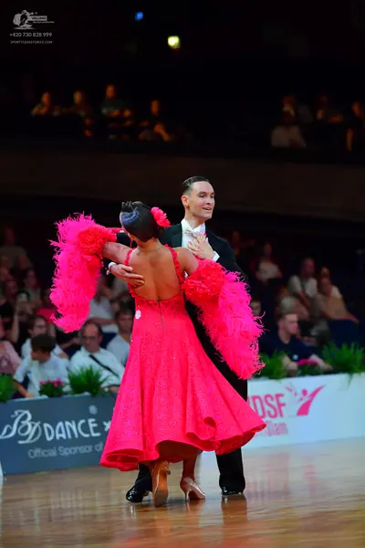 Dancesport competitor: Male dancer: black suit with a white shirt