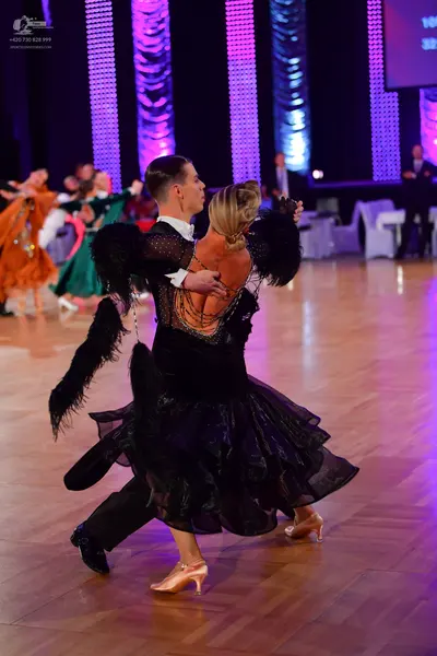 Dancesport competitor: Male dancer: black dance suit with a white shirt