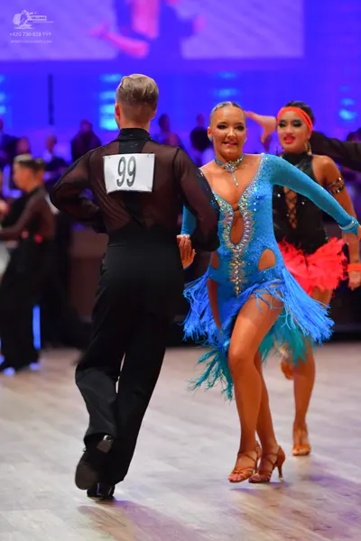 Dancesport competitor: Male dancer: black shirt with a sheer back panel and black trousers