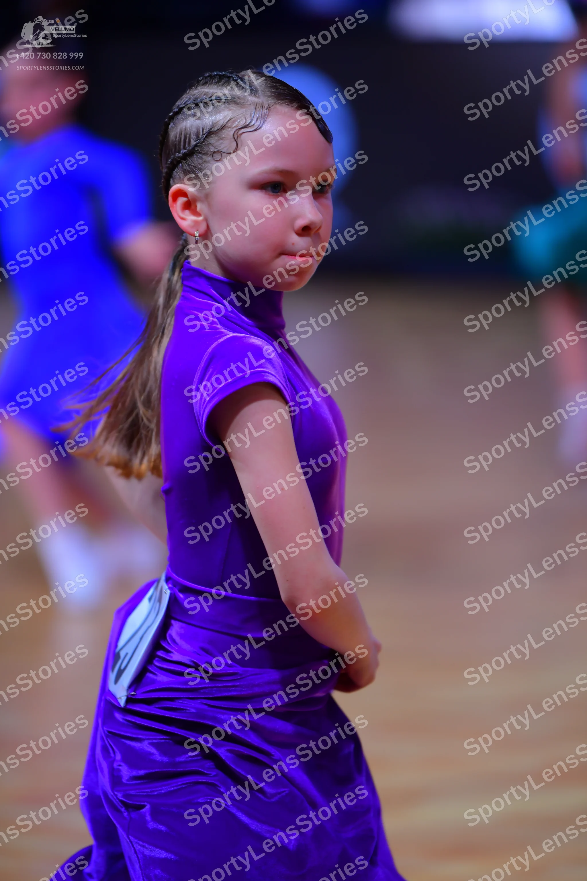 Dancesport competitor: Female dancer: purple satin dress with a high neckline and short sleeves