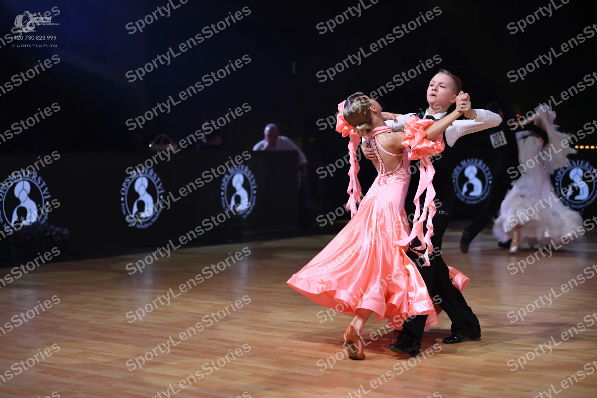 Dancesport competitor: Male dancer: white long-sleeved shirt, black trousers, and black dance shoes